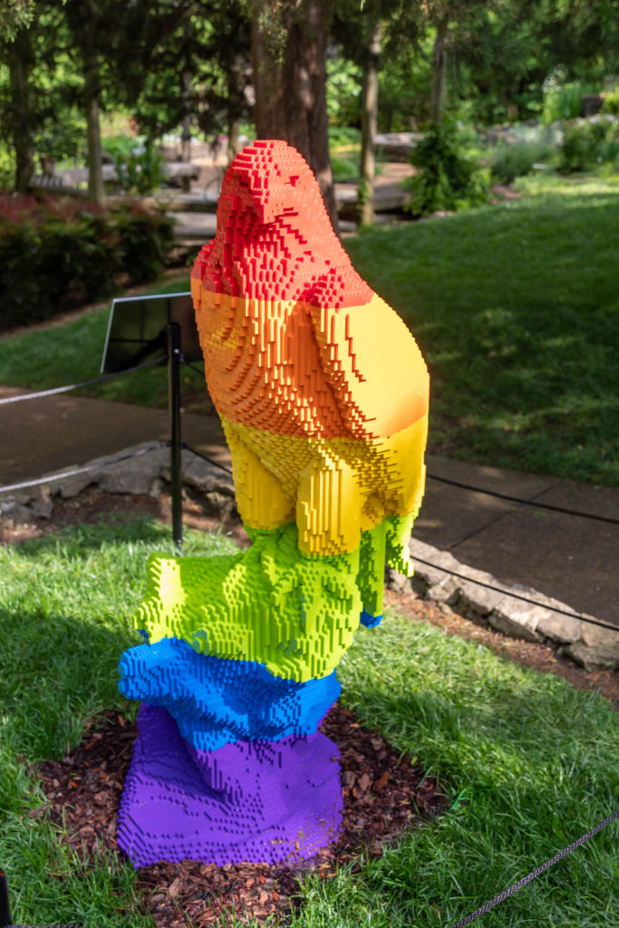 Bald eagle sculpture made with Legos that goes from red to orange to yellow to green to blue to purple in bands down the sculpture